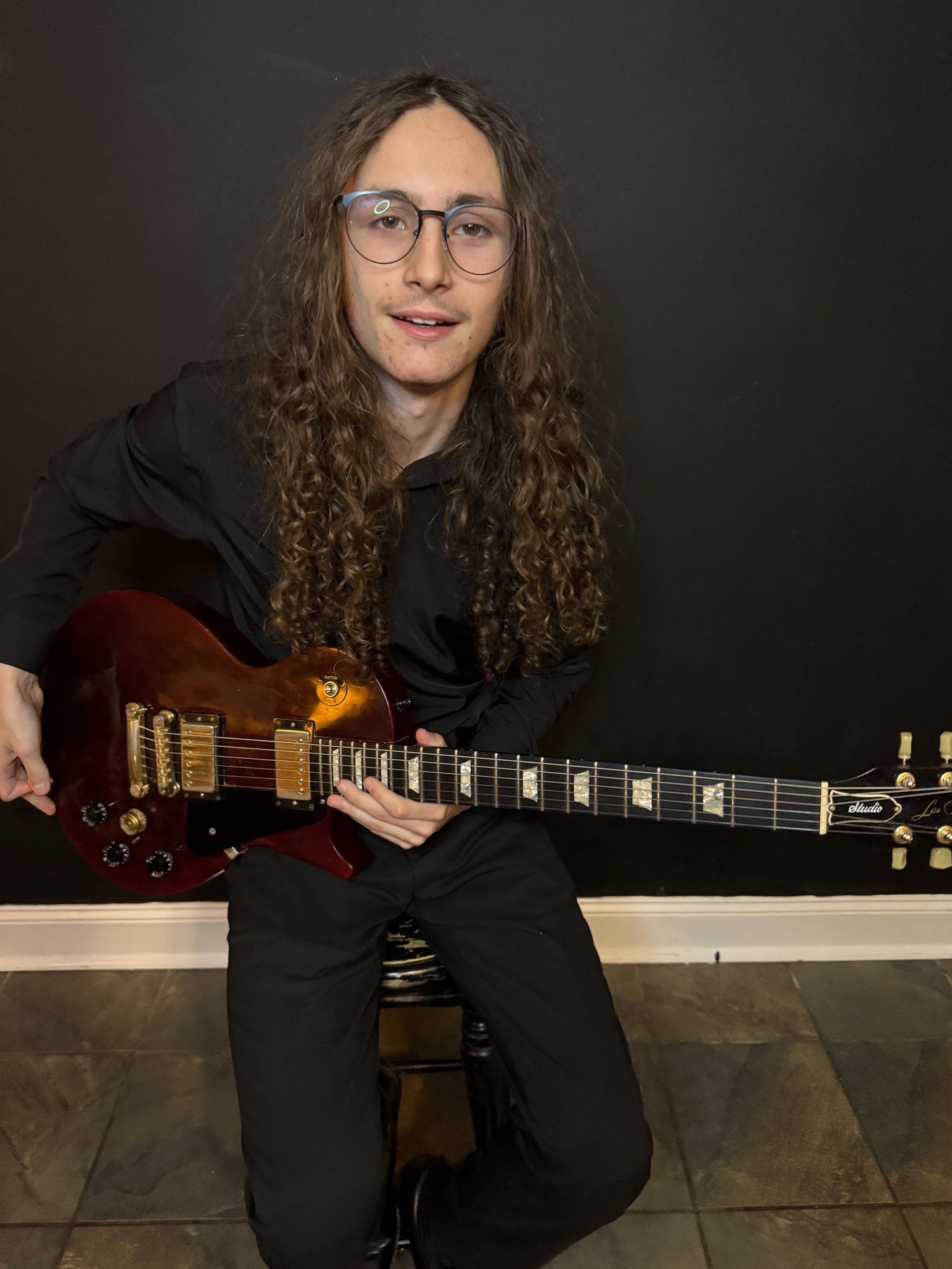 Kyser now — senior portrait with his red guitar